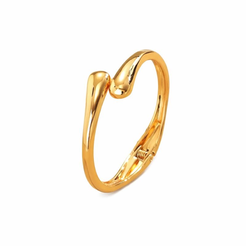 Pulseira dourada minimalista com design em forma de gota e acabamento polido